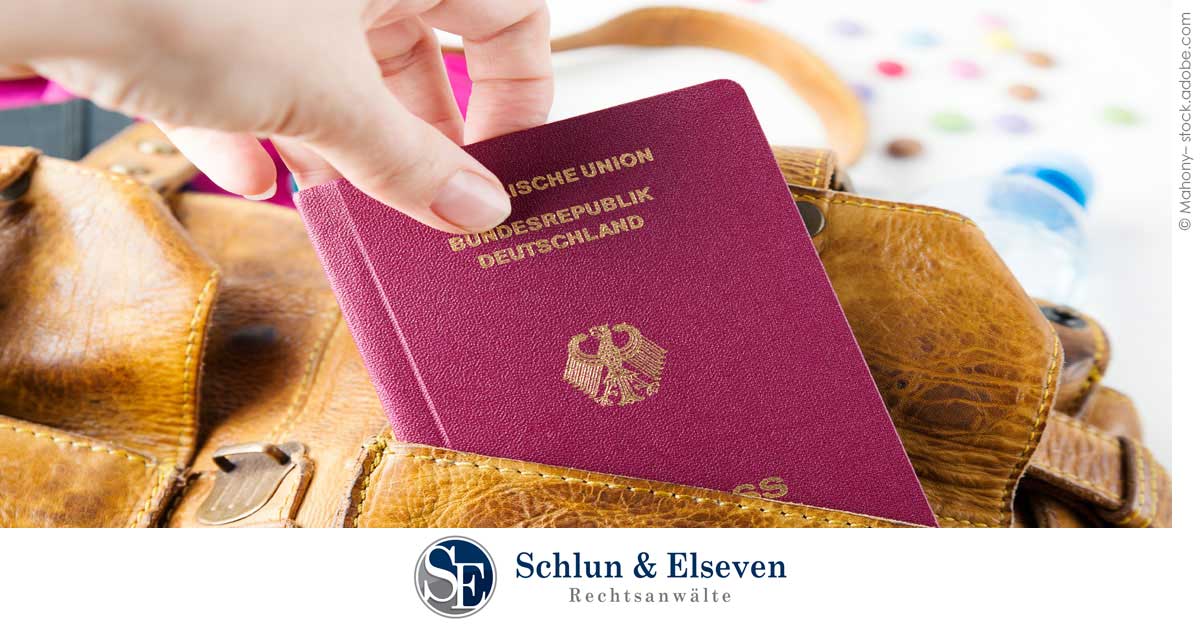 Person placing their German passport in a bag
